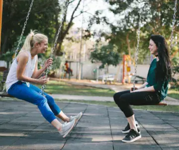 two women on swings