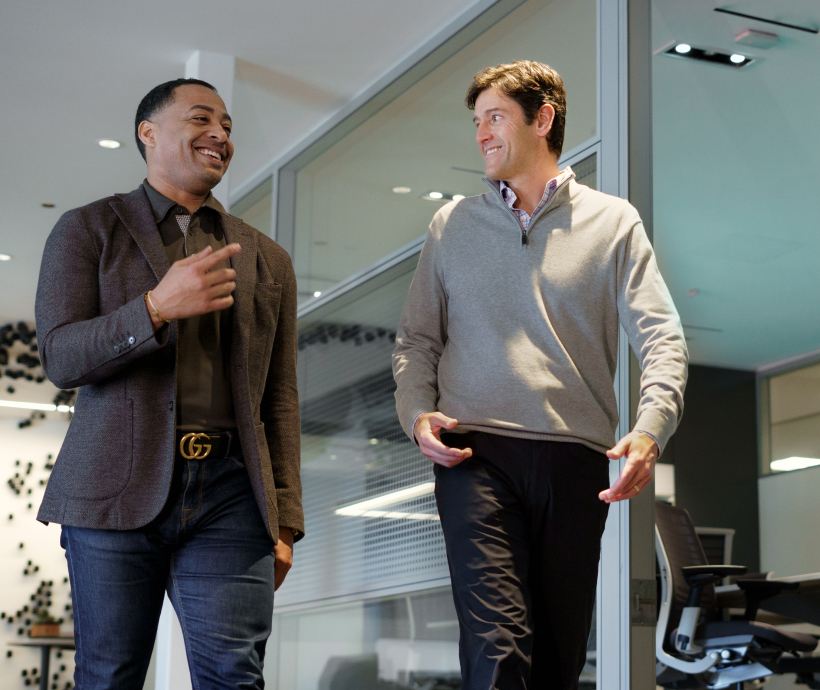 two men walking through office