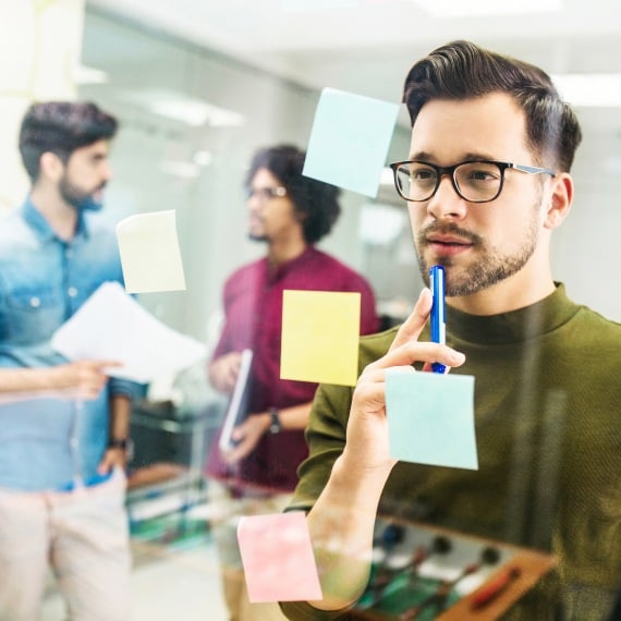 man working with sticky notes in office