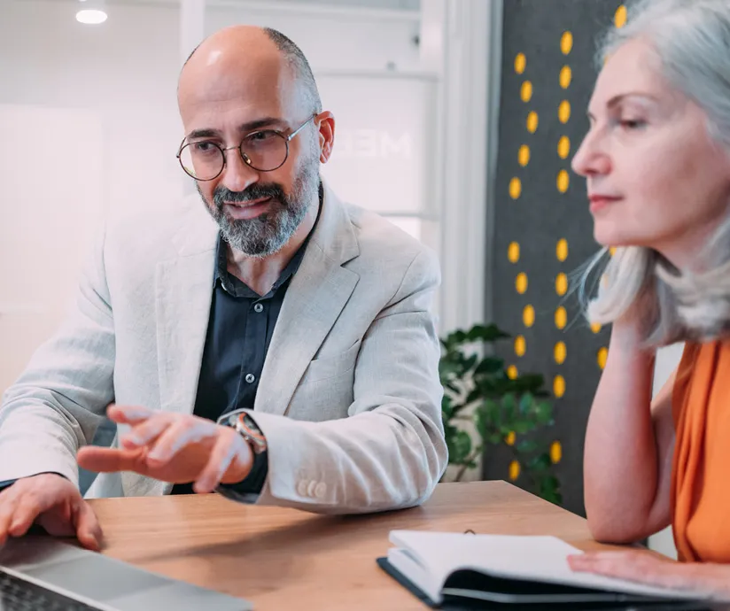 Man and woman looking at a laptop together