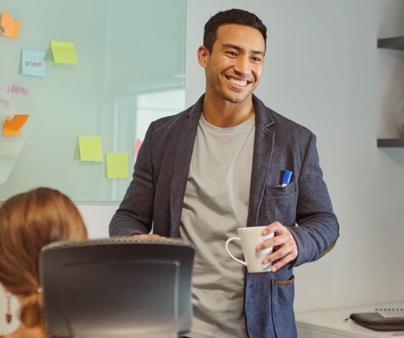 man in office with coffee cup