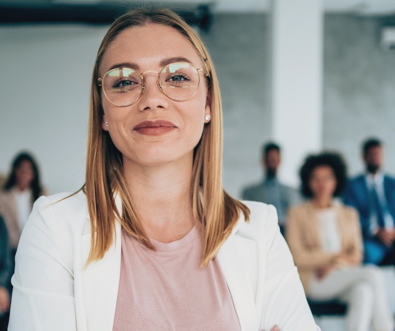 Woman wearing glasses smiling at the camera