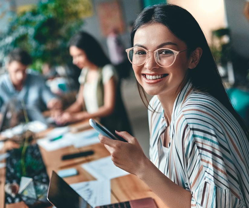 women holding phone at work