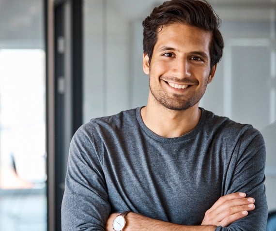 A man confidently smiling at the camera