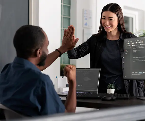 high fiving coworkers