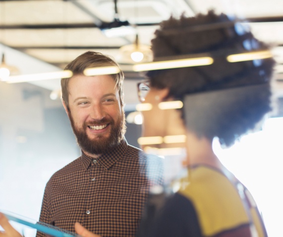 Smiling man in conversation with women