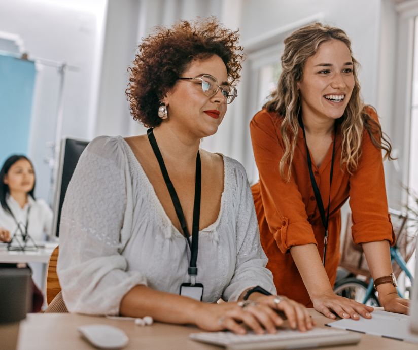 two women looking at computer