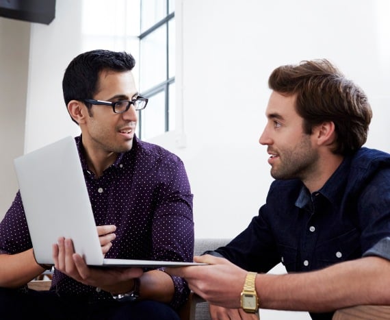 two men with laptop