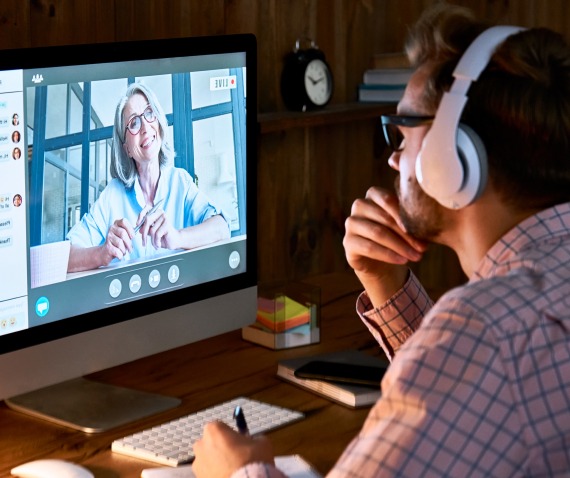 man talking to women via computer