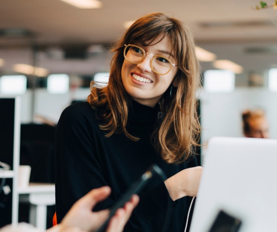 smiling women at her desk at work