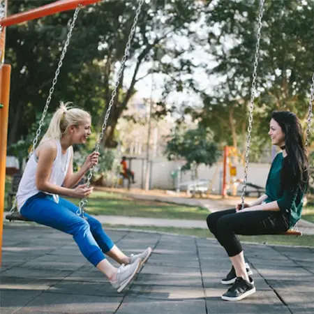 two women on swings