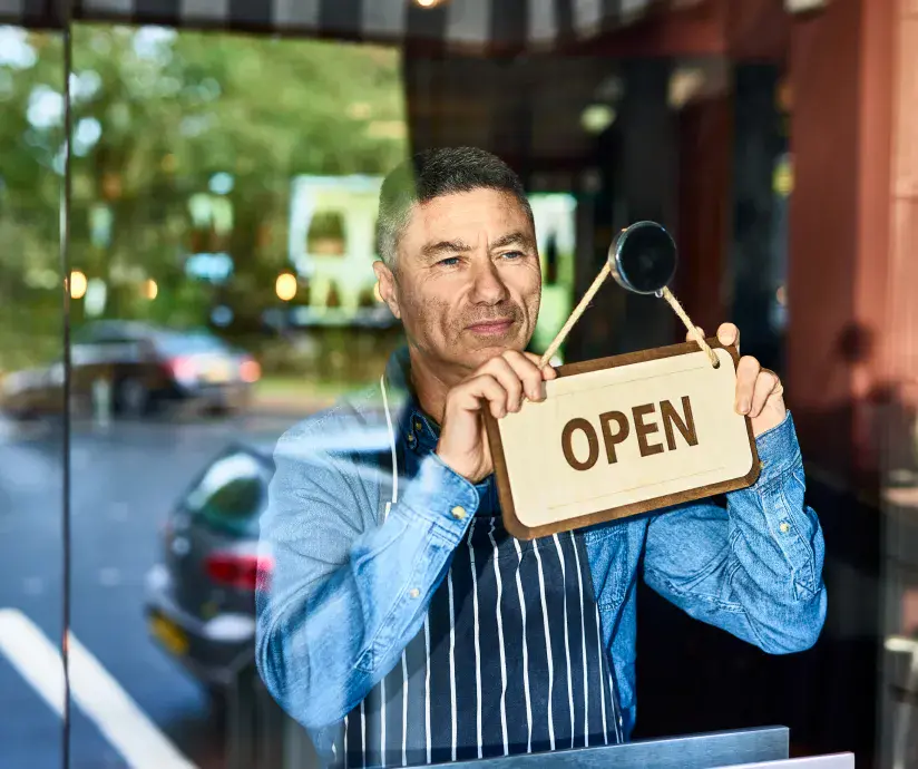 man hanging Open sign