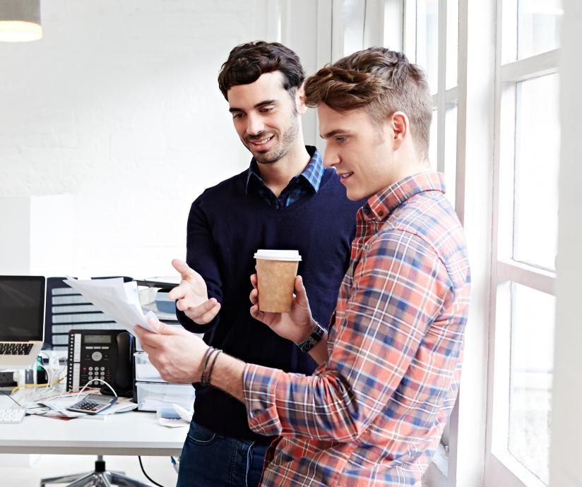 two men looking at paper