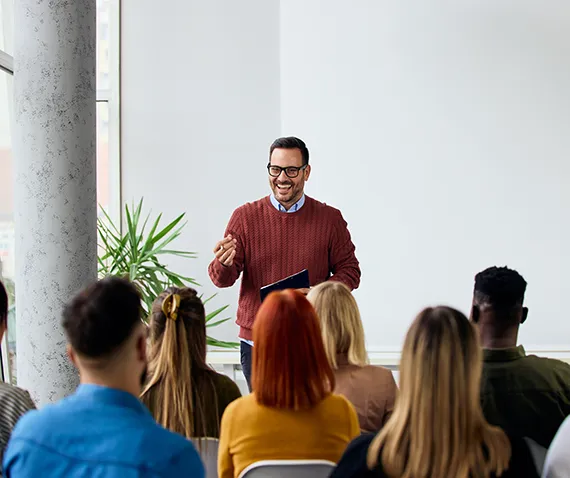 coach in front of group of coworkers