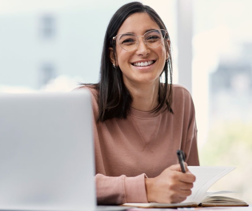 smiling women with pen and paper